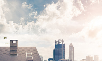 Obraz premium Brick house roof and modern cityscape at background