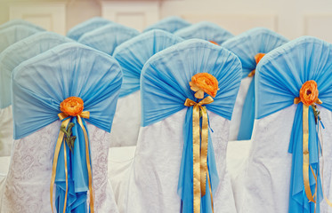 rows of chairs for a wedding ceremony decorated blue and a yellow decor