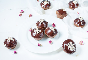 Chocolate cupcakes on grunge white wooden background