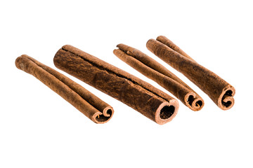 A set of four cinnamon sticks isolated on white background