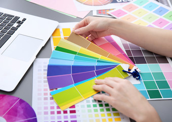 Young designer choosing color of interior while working in office, closeup