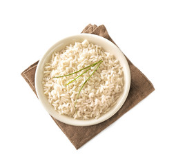Plate with brown rice on white background