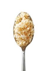 Spoon with brown rice on white background
