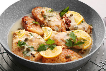 Fototapeta na wymiar Frying pan with delicious chicken piccata, closeup