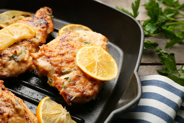 Tasty Italian chicken piccata in frying pan, closeup