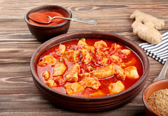 Chicken tikka masala in bowl on wooden table