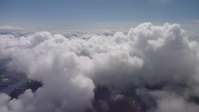 Aerial footage flying over the Pacific Northwest on cloudy day.