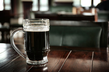 Glass of beer on table in pub