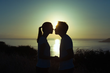 Young couple kissing on the beach. 