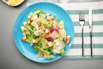Plate with chicken salad on table