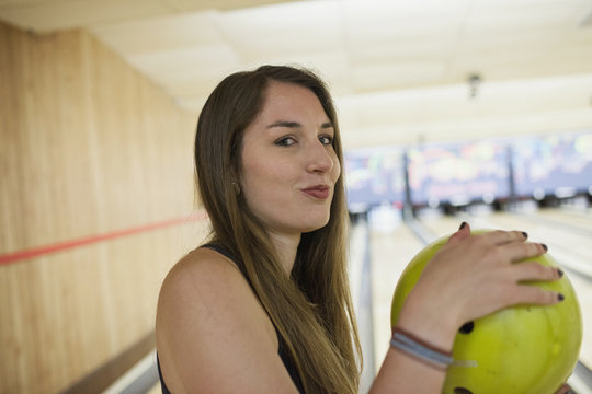 A young woman with a bowling ball.