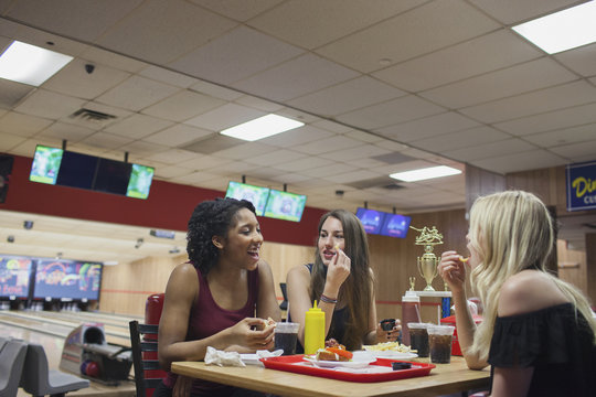 Three young women eating at a diner.