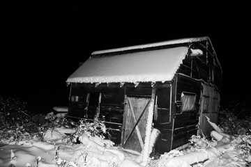 Old shack covered in snow