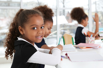 Cute African-American girls in classroom