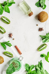 Skin care cosmetic with kiwi scrub on desk background top view mock-up