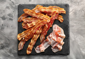 Slate plate with strips of bacon on table