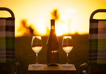 Relax and enjoy the sunset with a glass of wine. Vacation, relaxation, and day off concept.  