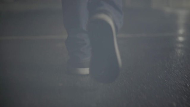 Man Walking Towards Skyline In Rain At Night
