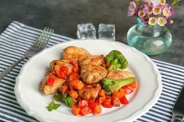Plate of chicken stir fry with vegetables on table