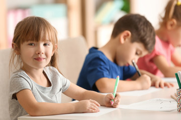 Cute kids drawing in classroom