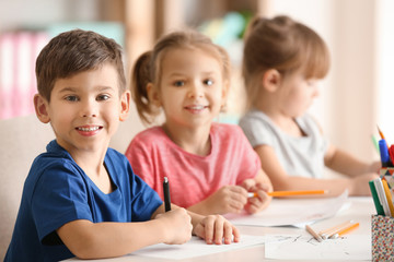 Cute kids drawing in classroom