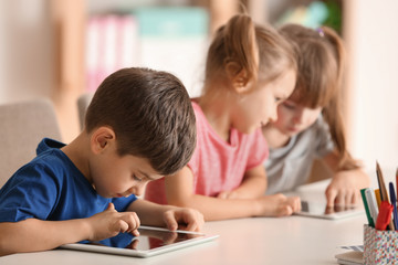 Cute kids using digital gadgets