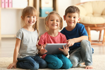 Cute kids using digital tablet
