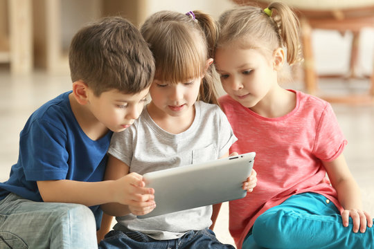 Cute kids using digital tablet