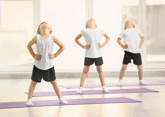 Naklejka premium Group of children doing gymnastic exercises
