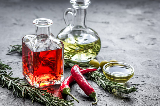 olive and chili oil with ingredients on kitchen table background