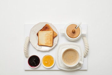 Flat lay of toasts with jams and coffee
