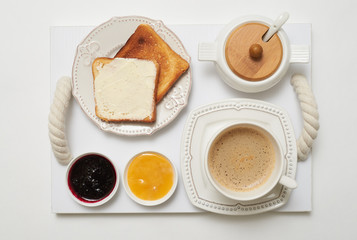 Light morning breakfast on service tray, flat lay