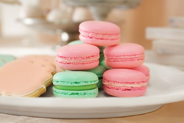 Plate with macarons and glazed cookies, closeup