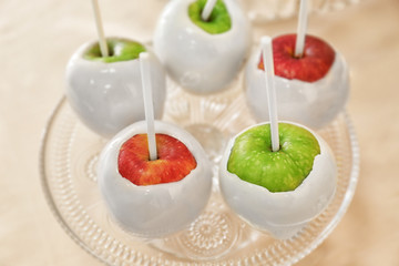 Vintage glass stand with candy apples, closeup