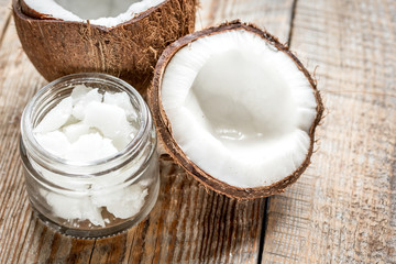 organic cosmetics with coconut on wooden background