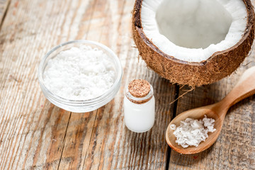 coconut oil for body care in cosmetic concept on old wooden table