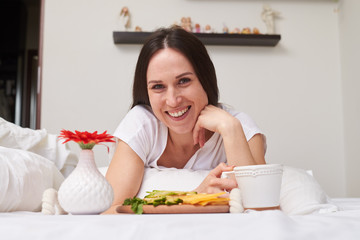 Obraz na płótnie Canvas Smiling woman being pleased with breakfast