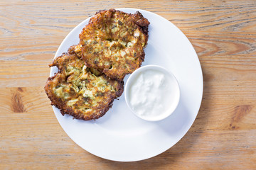 fried zucchini patties served with yogurt