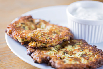 fried zucchini patties served with yogurt