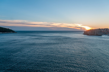 Naklejka na ściany i meble Lokrun island and Dubrovnik connected by a streaking sunset