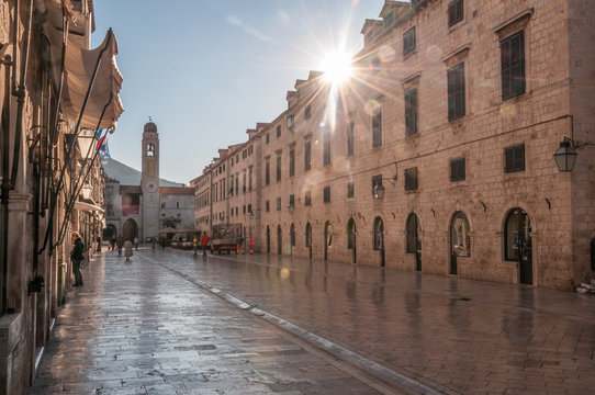 The sun rising from behind the streets of Dubrovnik on a quiet morning.
