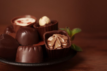 Plate with delicious chocolate  candies, closeup