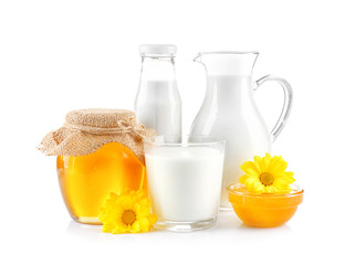 Composition with milk and honey on white background