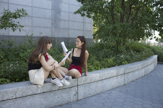 Two young women reading