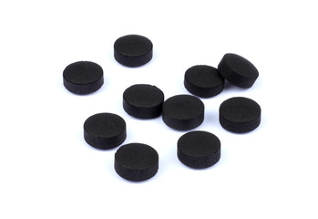 activated carbon pills isolated on white background