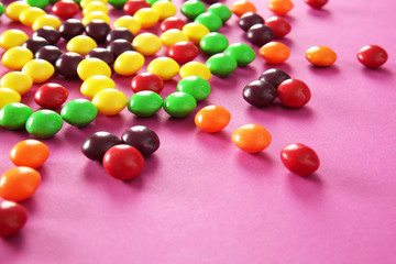 Pattern made of colorful candies on color background, closeup