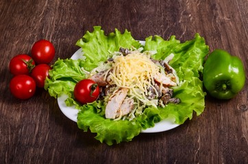 Salad with meat on lettuce leaf