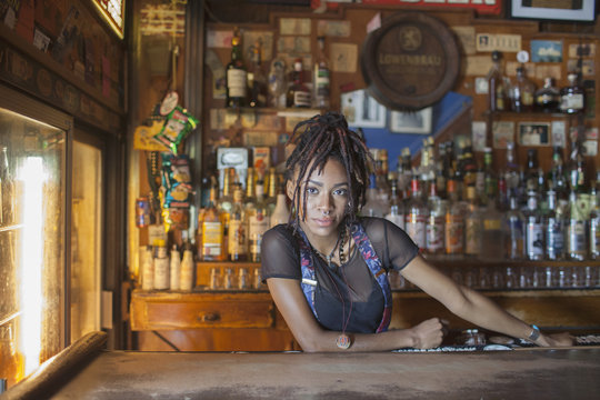 A young woman at a bar.