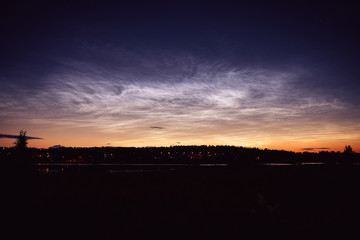 Noctilucent clouds at night sky