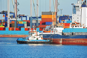 Tugboat assisting bulk cargo ship